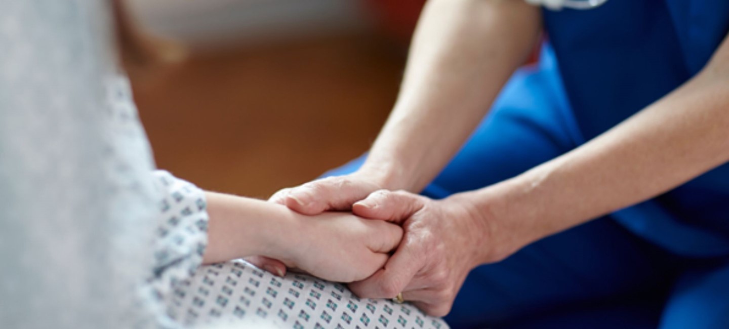 HCP holding patients hand