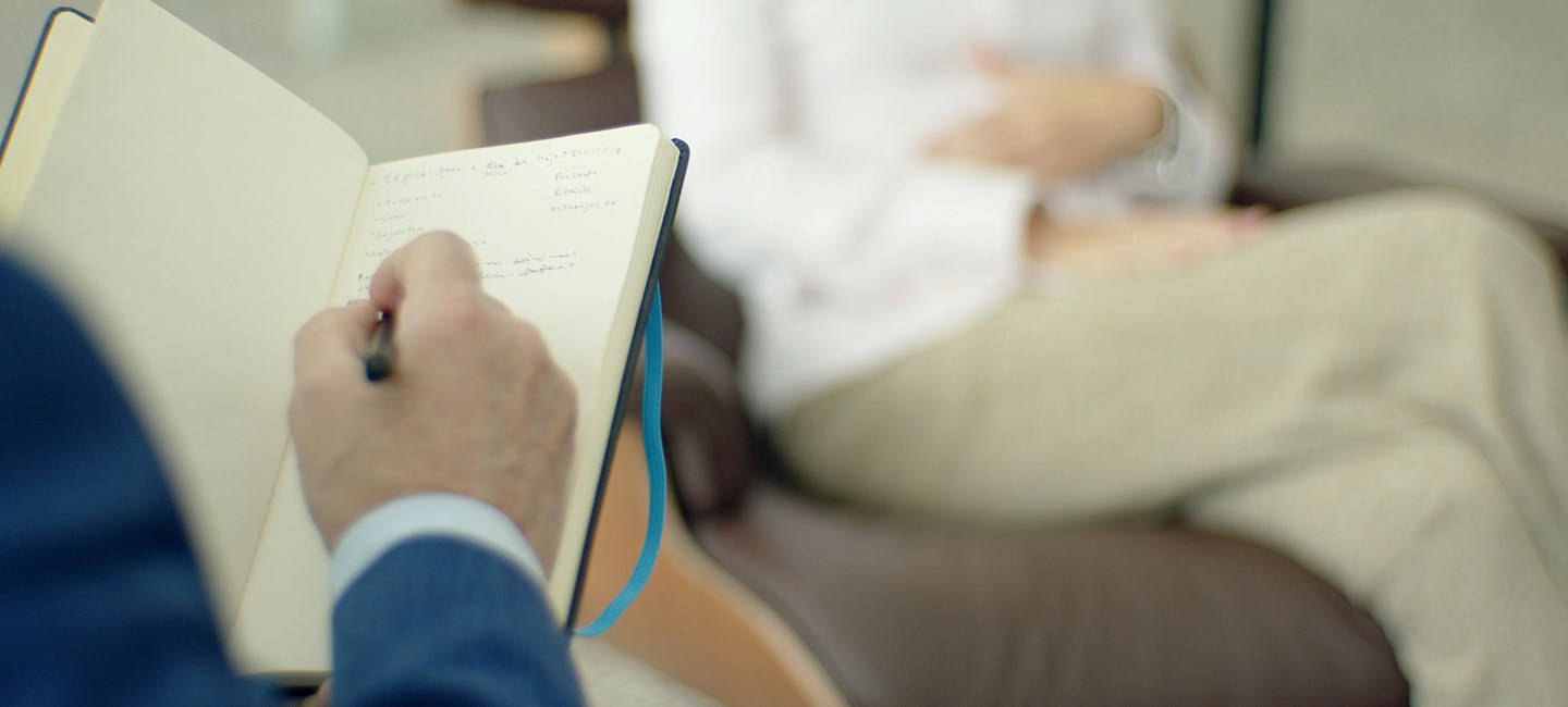 A hand writting in an open notebook